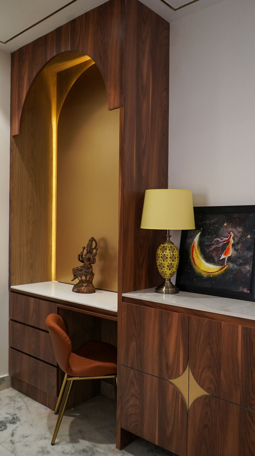 Samsara Residence puja unit with warm gold lighting